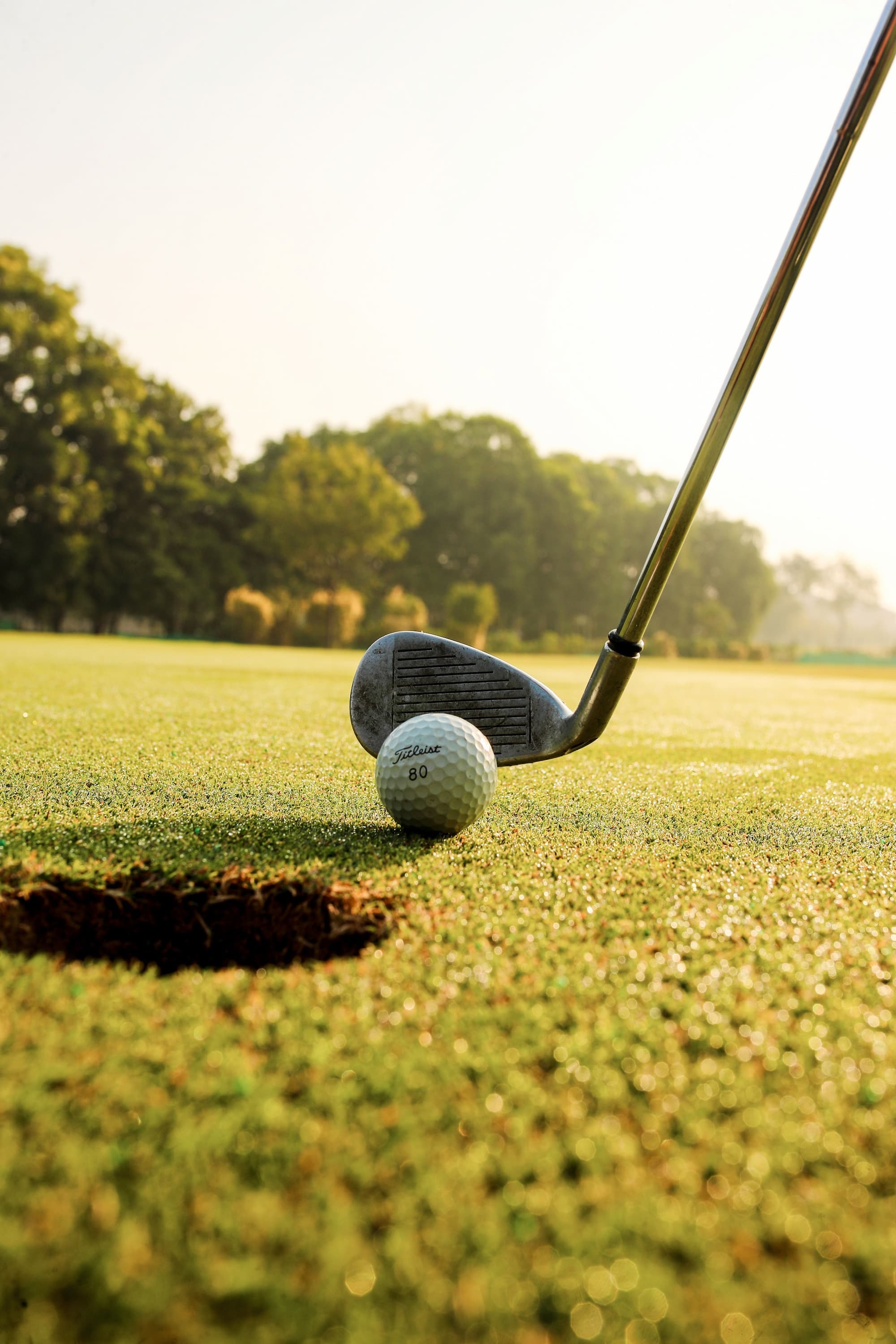 A golfer mid-swing on the fairway